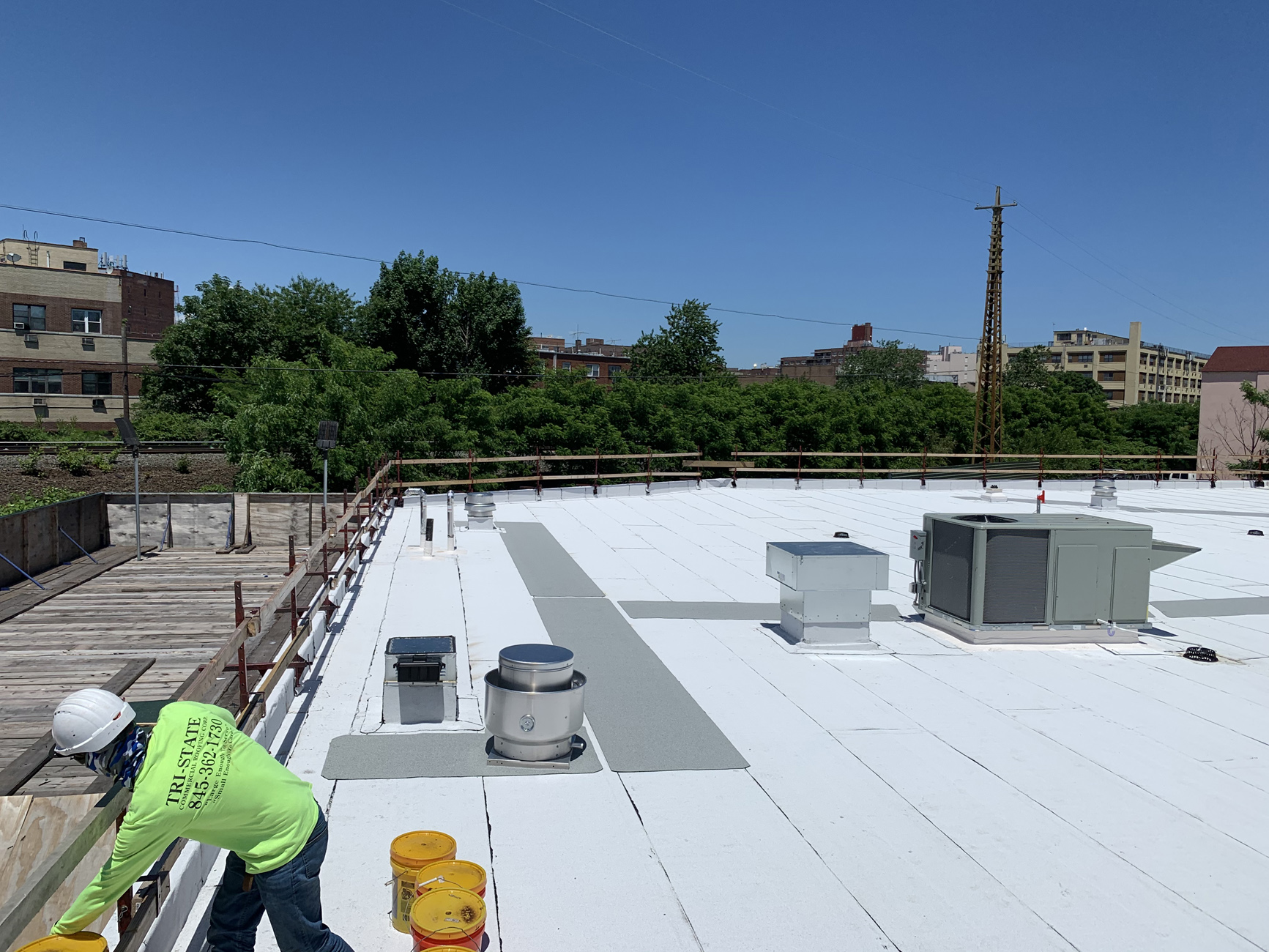 Commercial roofing installation cityscape background